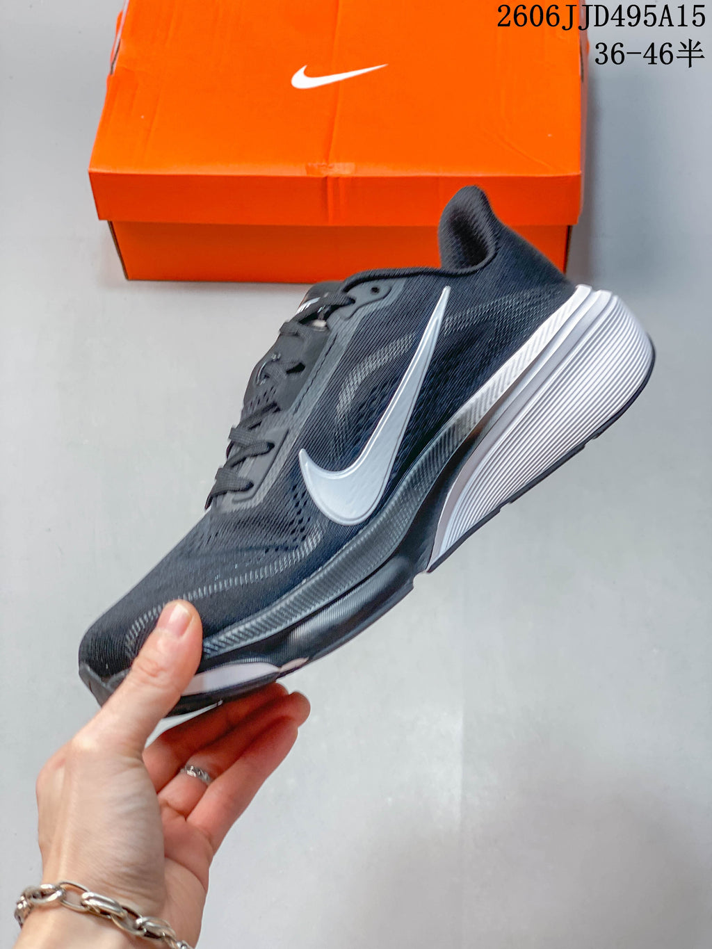 Side view of the dark gray Nike Pegasus 42 with white Swoosh