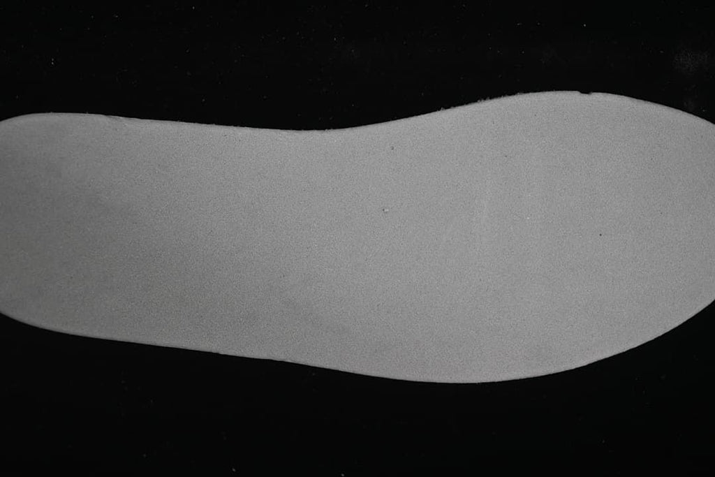 Close-up view of a plain light grey shoe insert