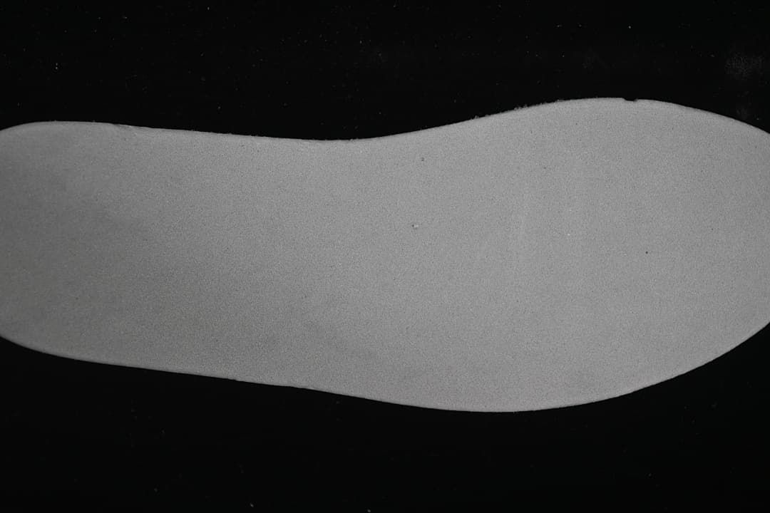 Close-up view of a plain light grey shoe insert