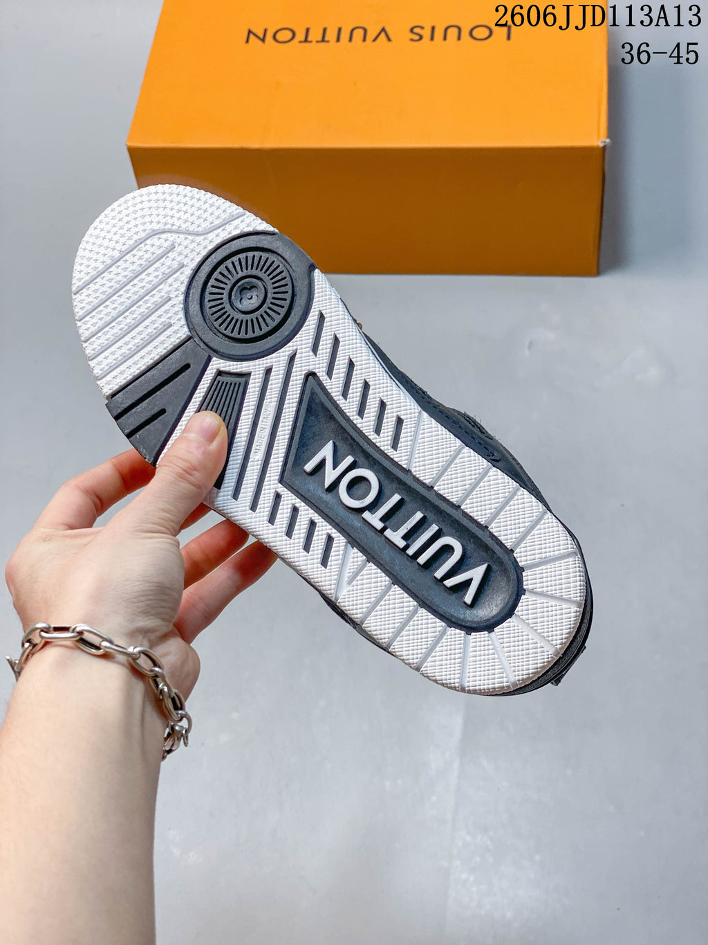 View of the sneaker outsole showing a white-and-dark patterned tread.