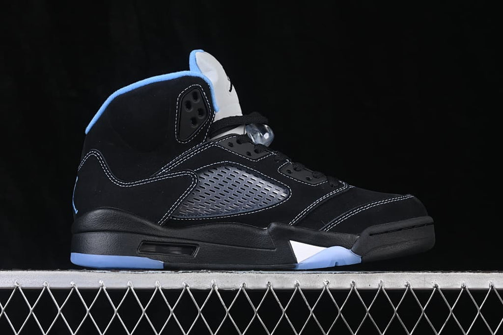 Side view of a black and University Blue Air Jordan 5 Retro sneaker.