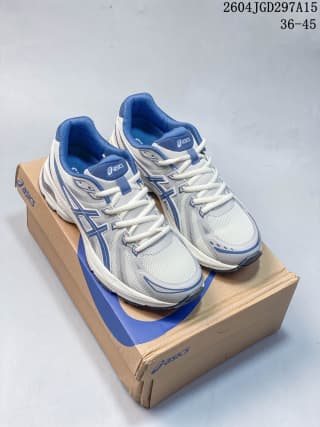 Pair of white and blue ASICS sneakers displayed on an ASICS shoe box.