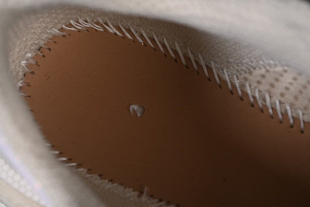 Close-up inside the sneaker showing the insole and stitching