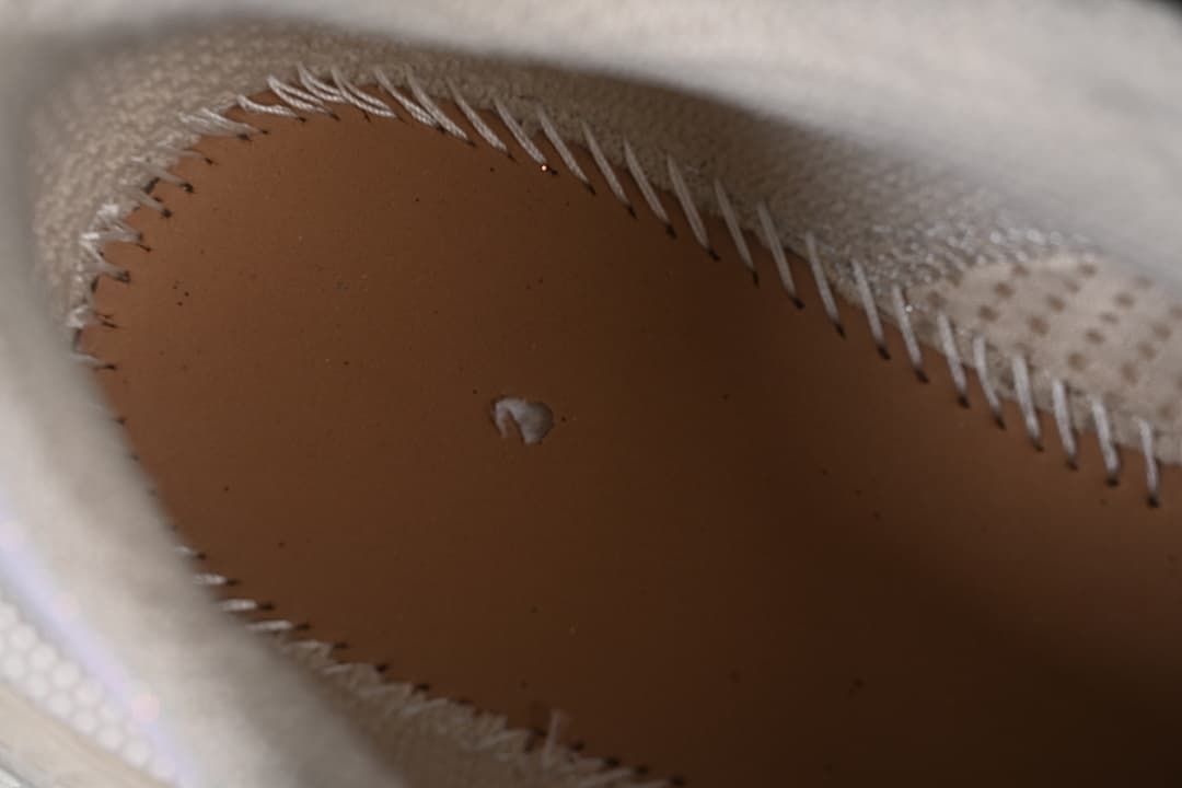 Close-up inside the sneaker showing the insole and stitching