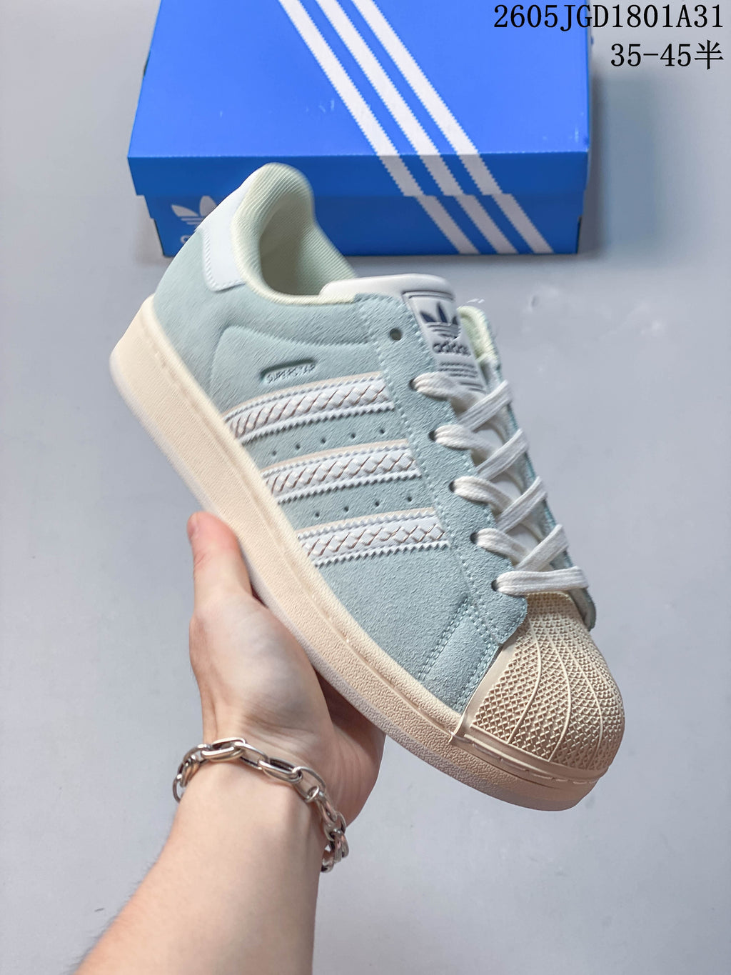 Angled view of the light blue Campus 00s sneaker with cream accents