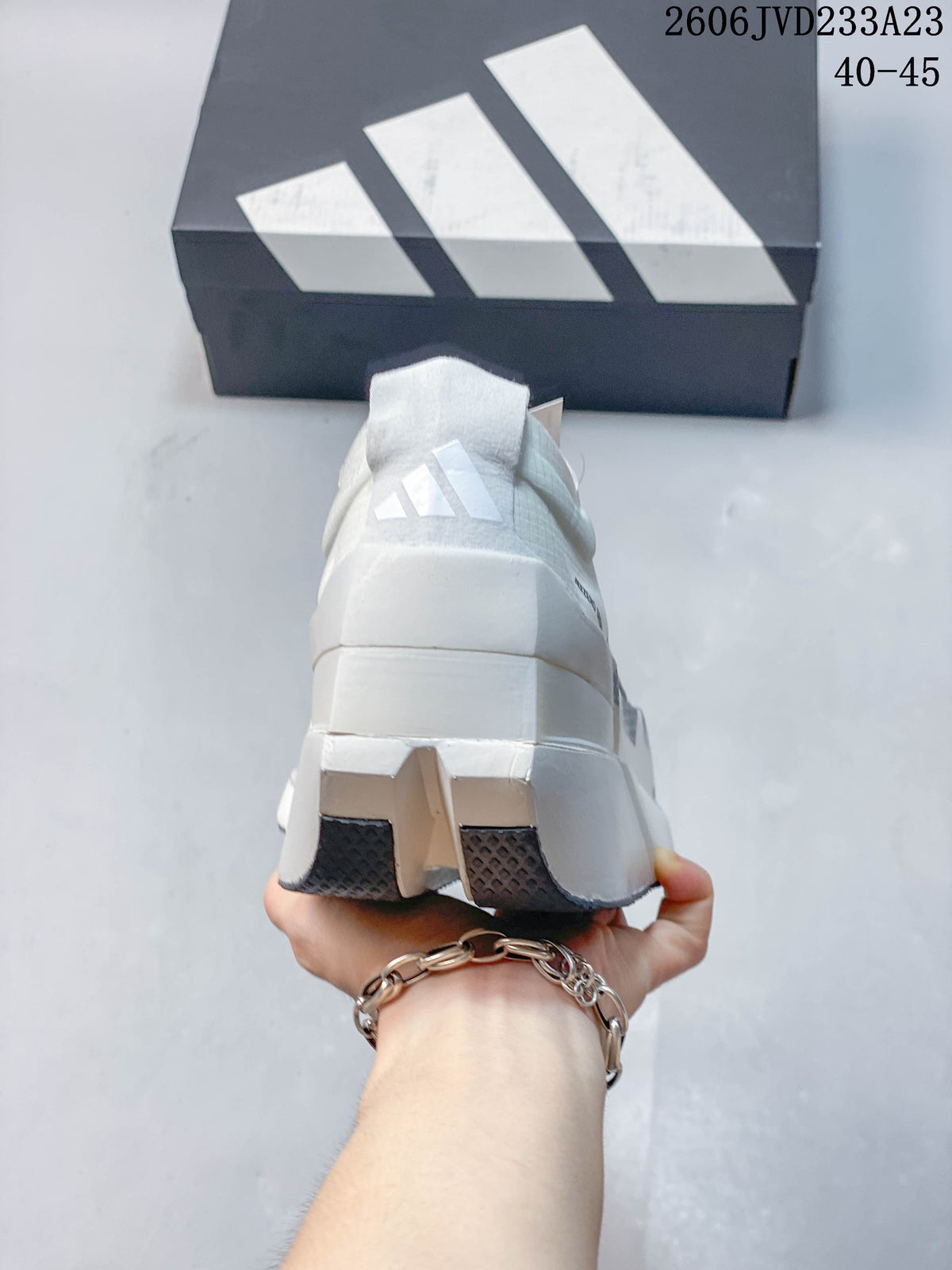 Rear view showing the sculpted heel and outsole of a white adidas running shoe