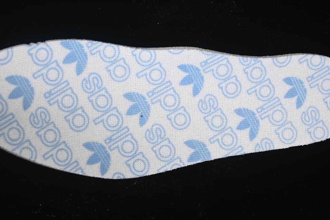 Close-up of the insole with blue adidas and trefoil pattern