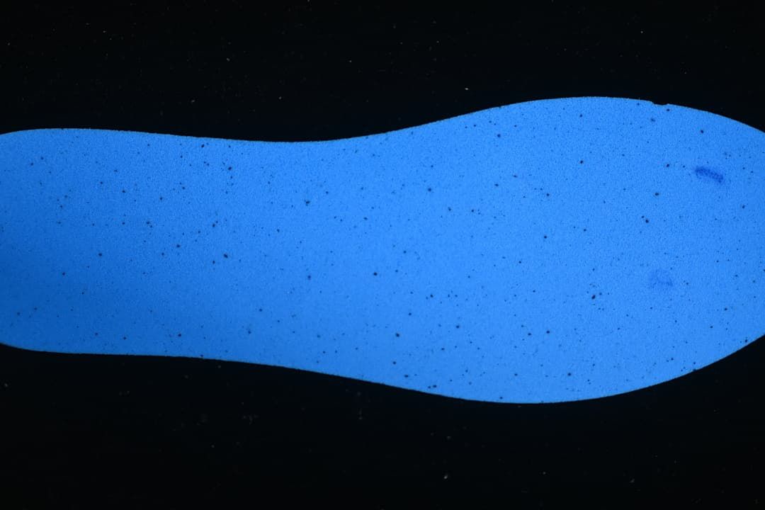 Blue insole shown separately against a dark background