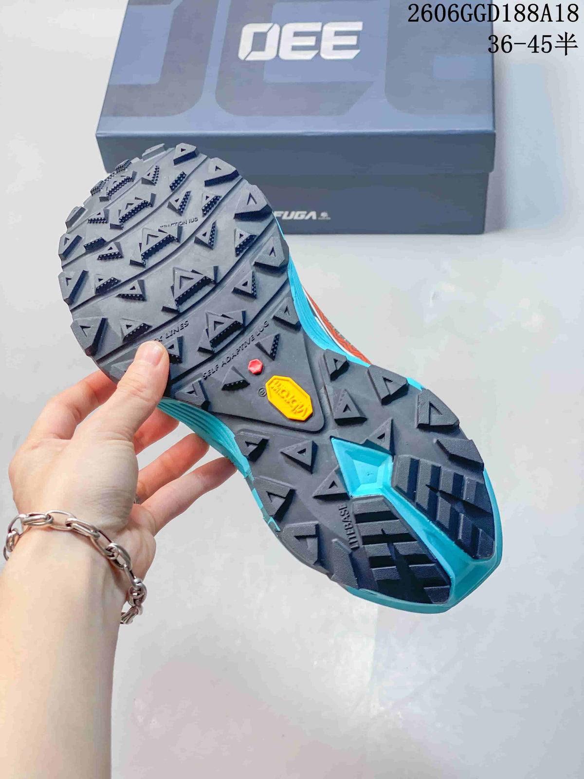 Close-up of the trail shoe outsole with a lugged tread pattern