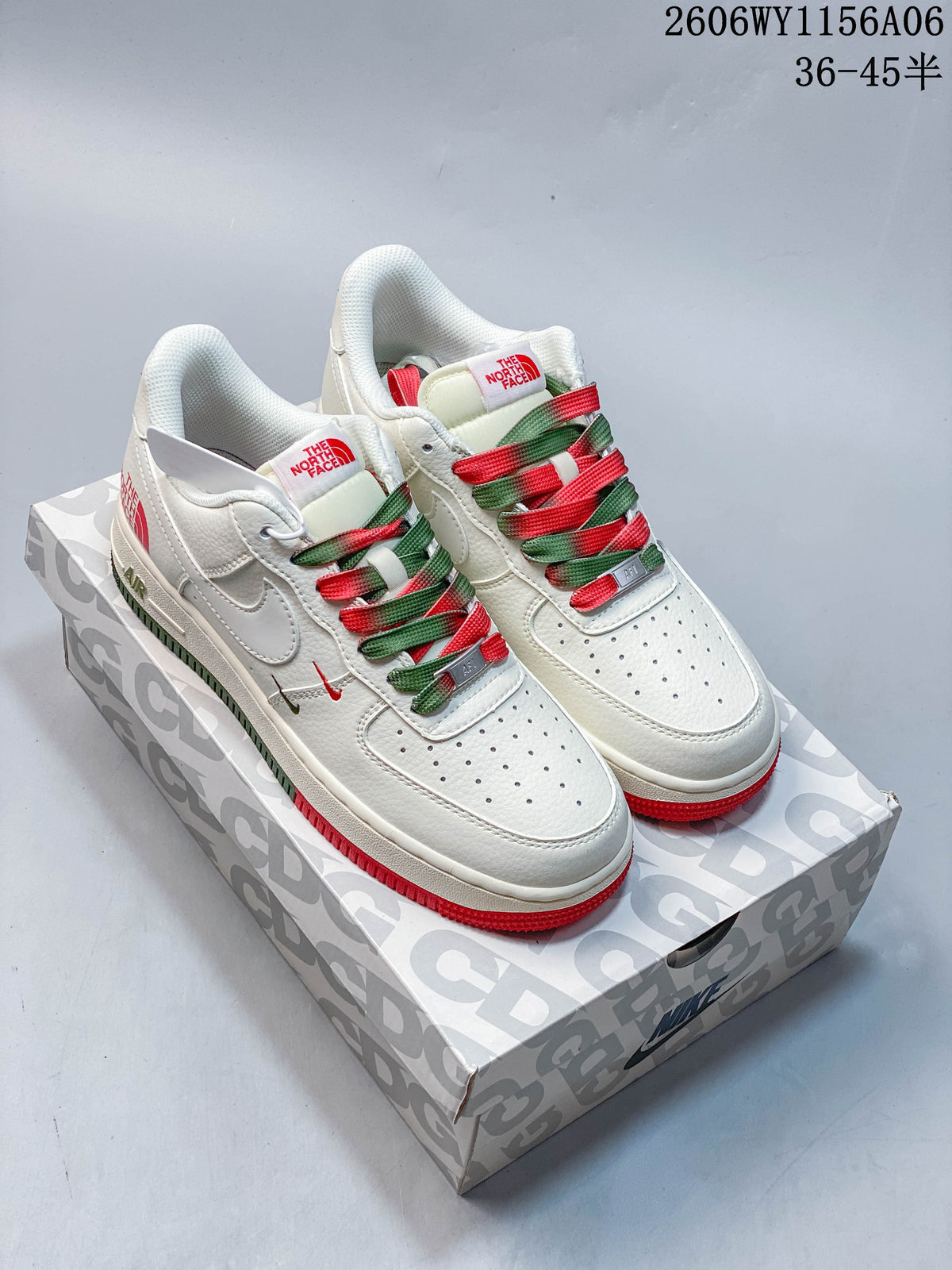 Pair of white low-top sneakers with red and green accents and multicolor laces