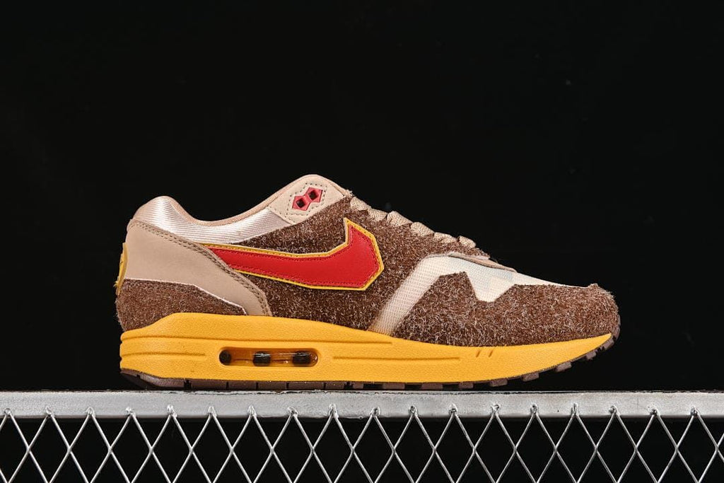 Outer side profile showing the red Swoosh, shaggy brown overlays, and yellow midsole.