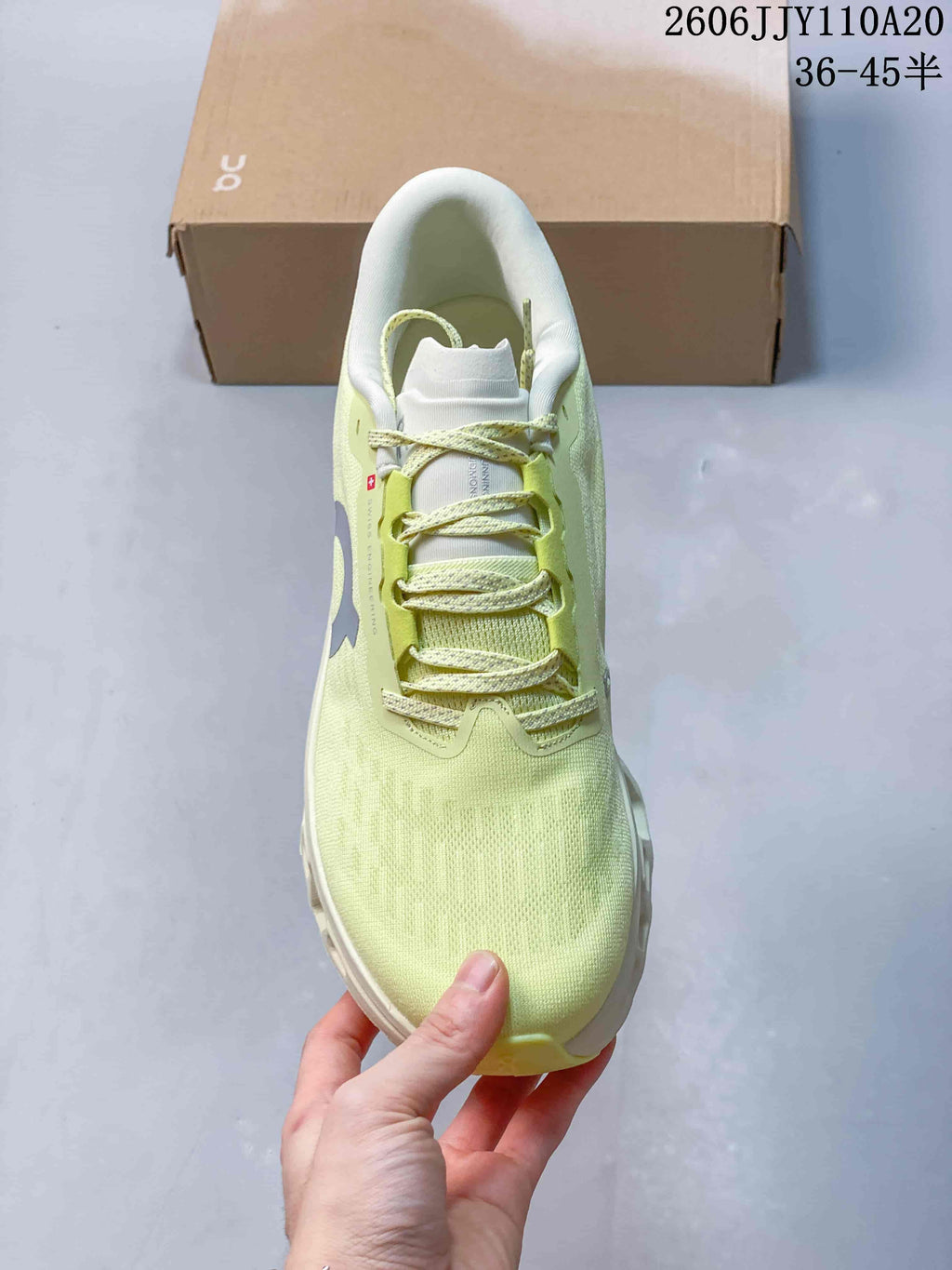Top view of the shoe highlighting its laces and pale yellow upper