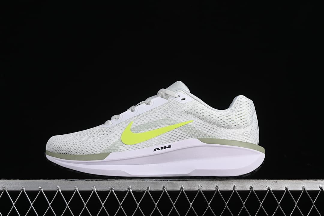 Side view of white Nike Winflo 11 running shoes with a bright volt Swoosh and sculpted sole.