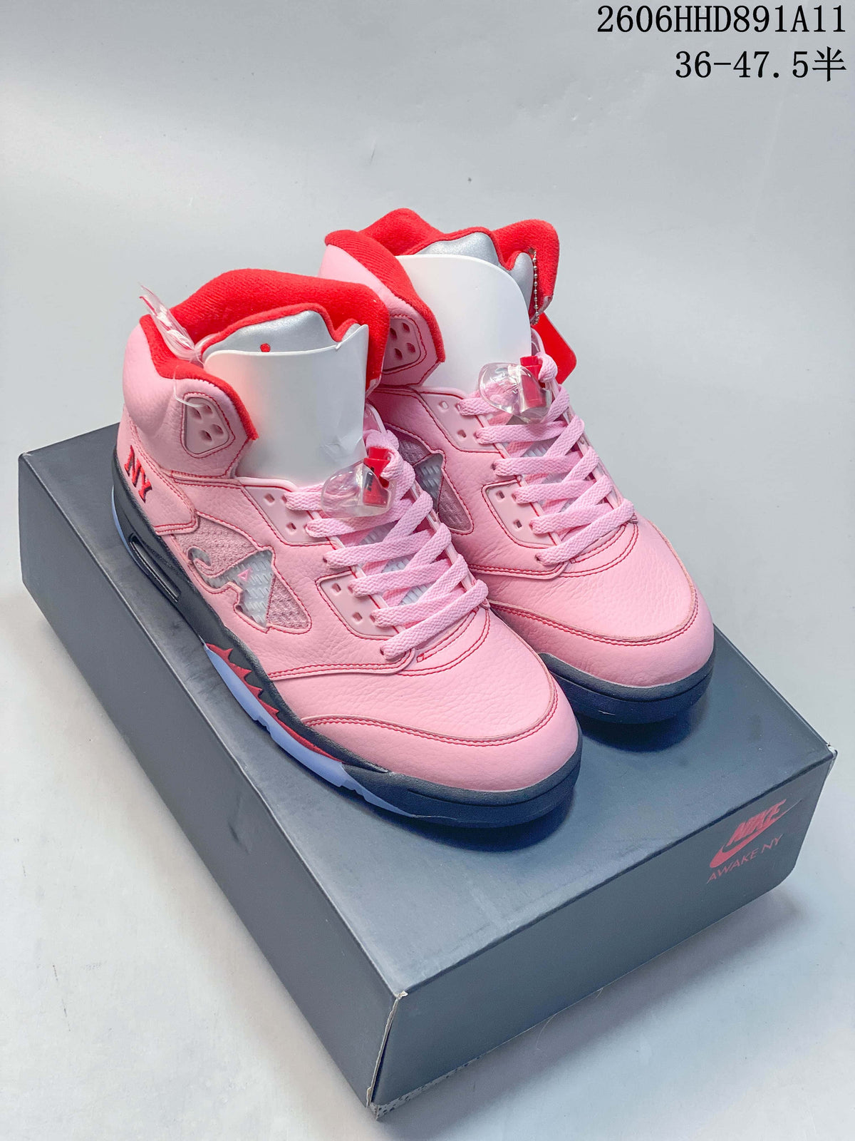 Pair of pink Awake NY x Air Jordan 5 style mid-top sneakers on a shoebox; image overlay shows code 2606HHD891A11 and a size range.