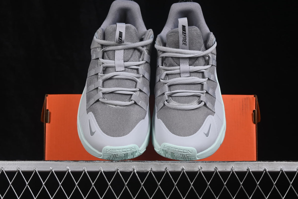 Top view of the pair showing gray mesh uppers, lace-up fastening, Nike branding, and pale green toe outsoles.