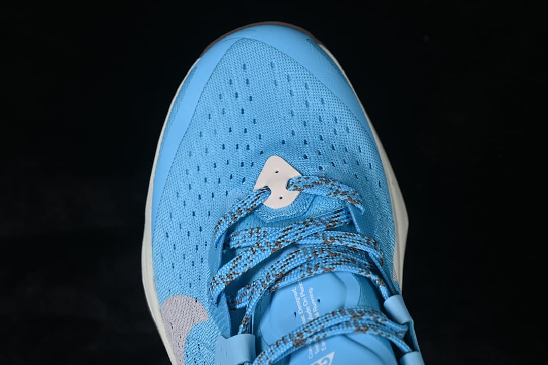 Top view of the perforated blue toe box and patterned laces.