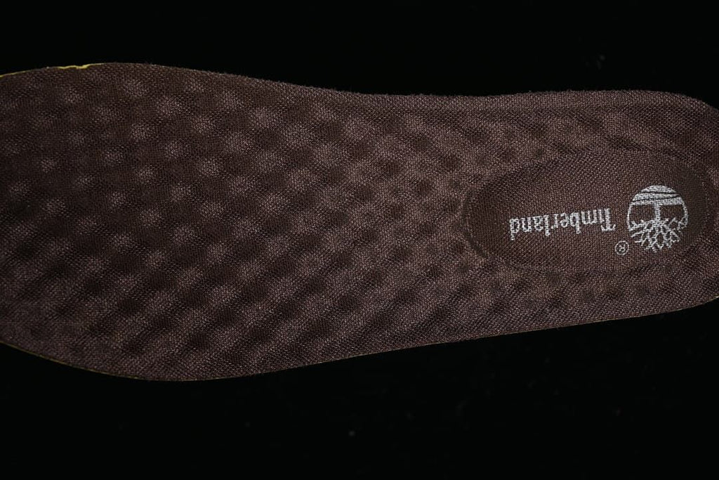 Close-up of a dark brown textured insole with Timberland branding.