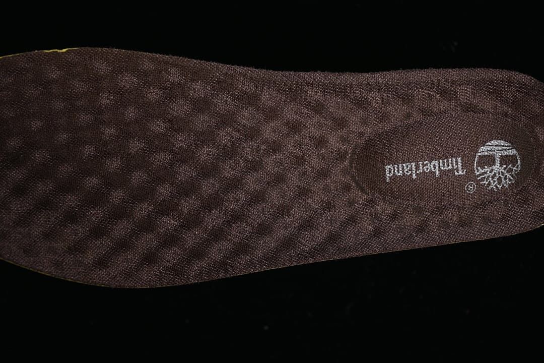 Close-up of a dark brown textured insole with Timberland branding.