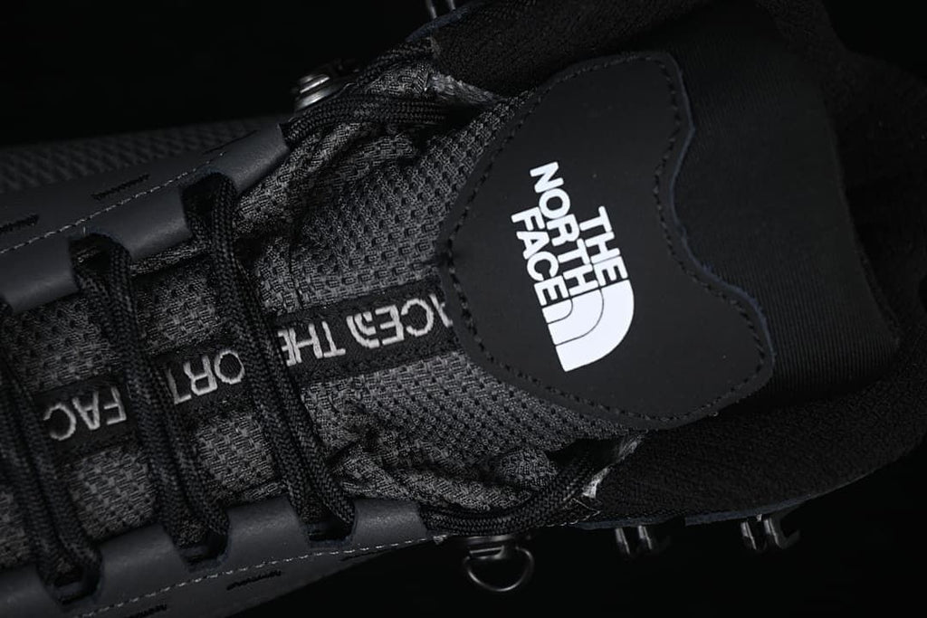Top close-up of the boot tongue, laces and logo patch