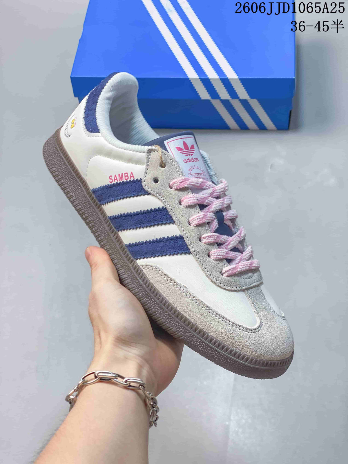 Side view of a white low-top sneaker with blue stripes, pink laces, and a gray-toned outsole