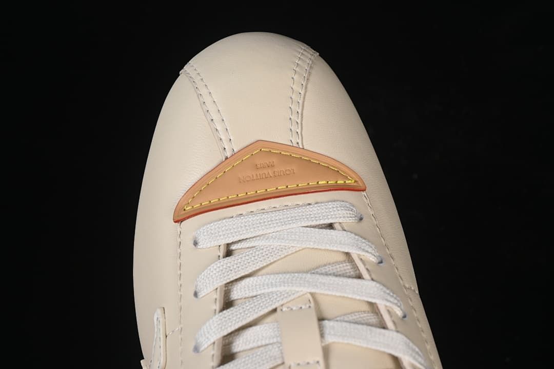 Top-down close-up of toe panel and tan accent