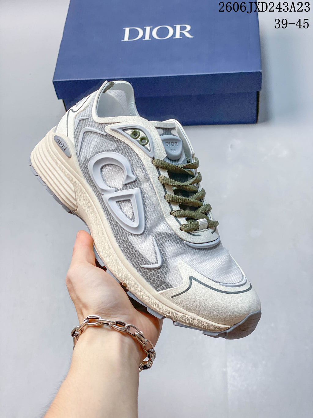 Light gray mesh low-top sneaker with cream sole and olive laces.