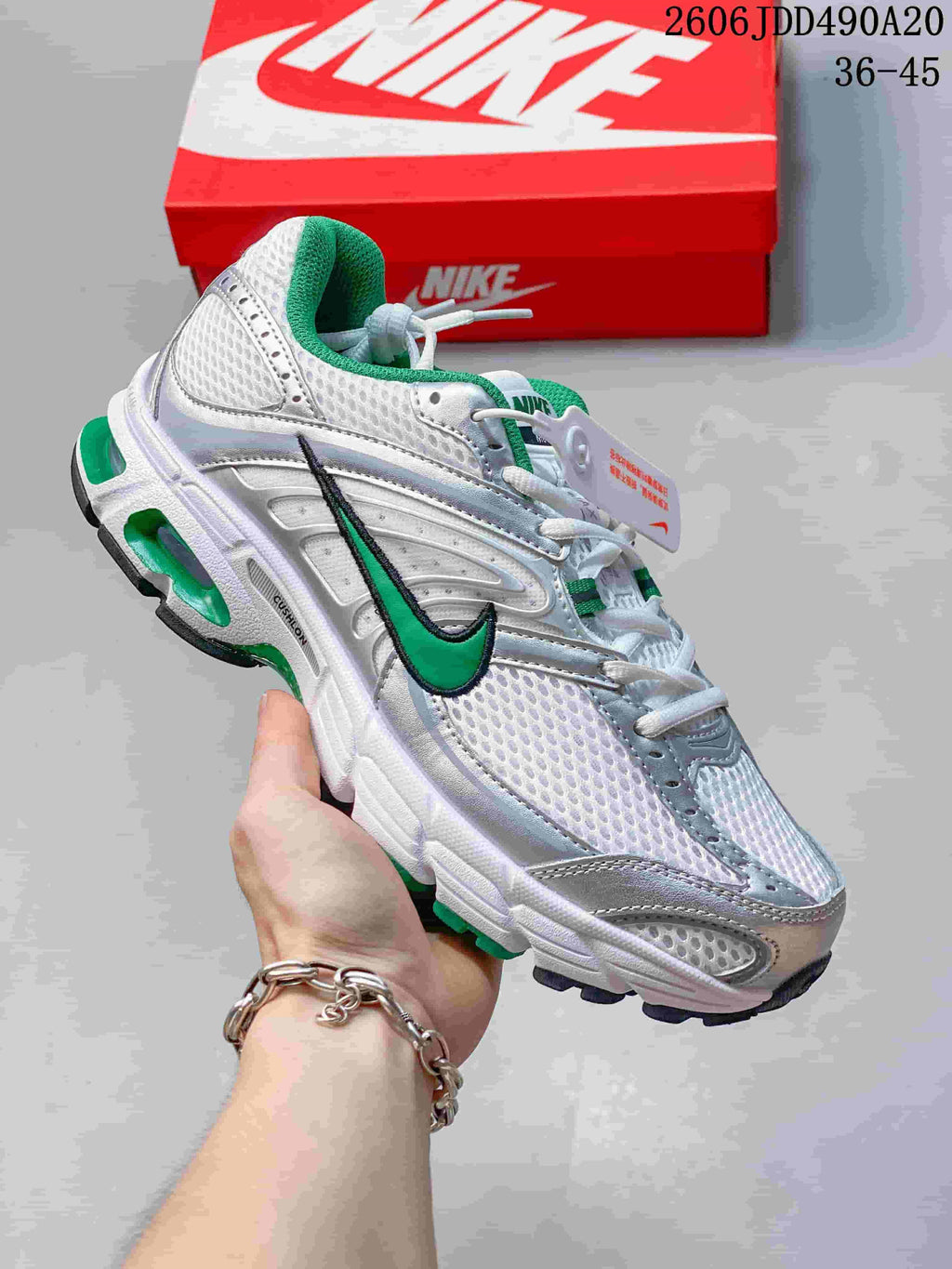 White mesh Nike Air Max Moto 2K sneaker with green accents