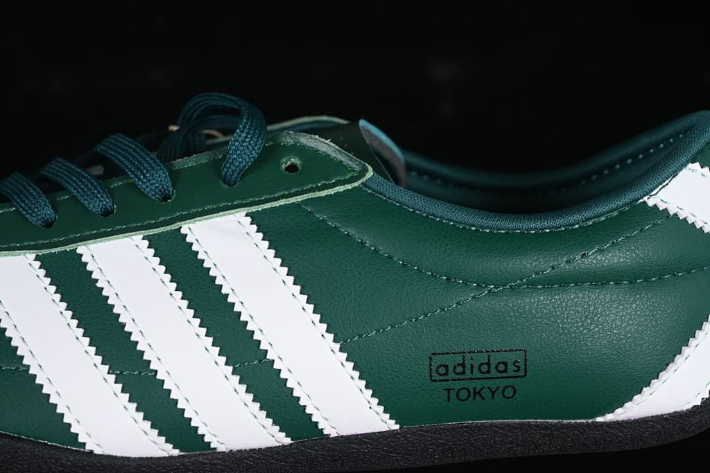 Close-up of the white side stripes and adidas Tokyo side branding.