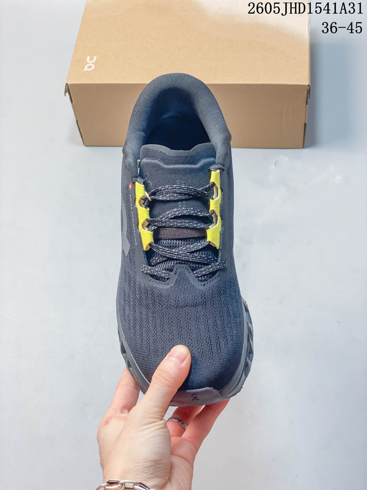 Top view of a charcoal running shoe with dark laces and yellow lace details.
