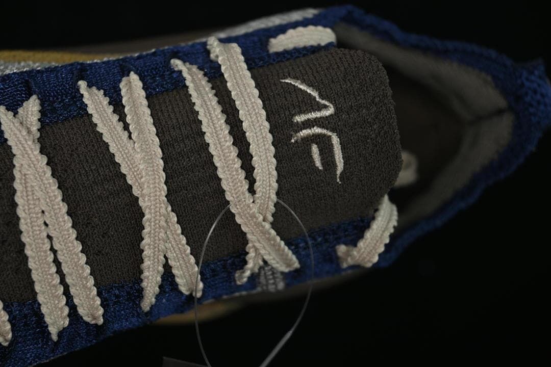 Close-up of the tongue and cream-colored laces