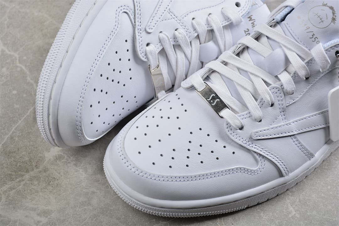 Close-up of perforated toe panels and lace-up details on white sneakers