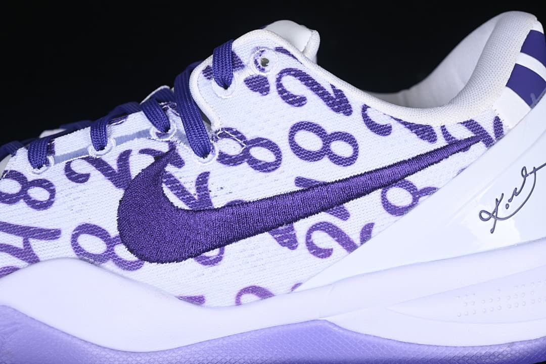 Close-up of purple laces, Swoosh and patterned white upper
