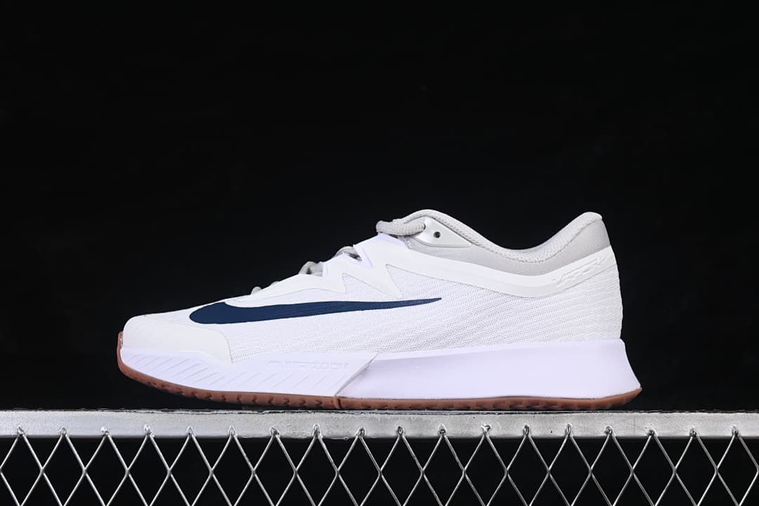 Side view of the white Nike Zoom Vapor Pro 3 shoe with navy Swoosh.