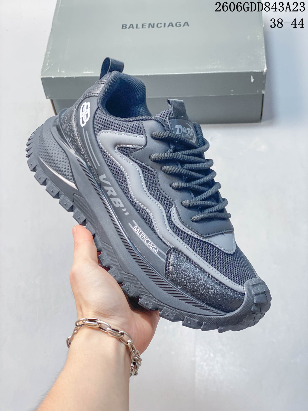 Angled side view of the gray sneaker with visible branding