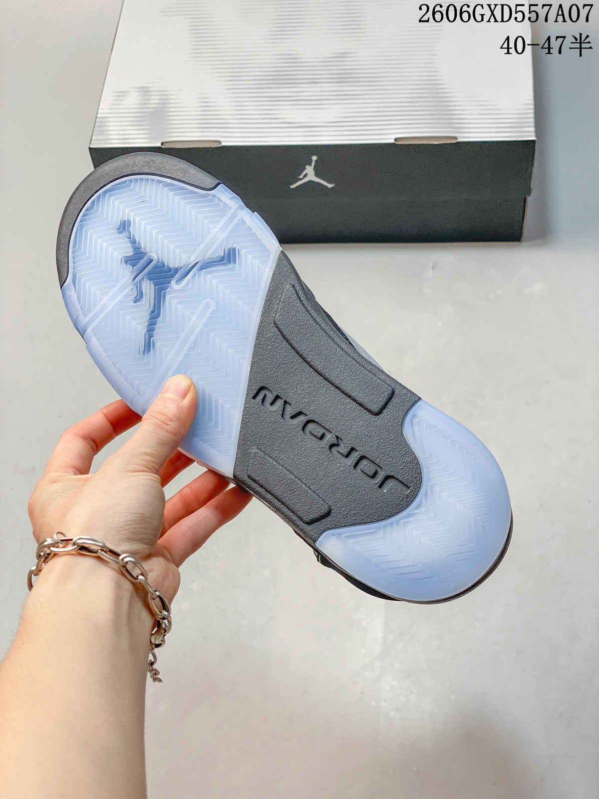 Close-up of the translucent light blue outsole and gray midfoot of a Jordan Air Jordan 5 sneaker.