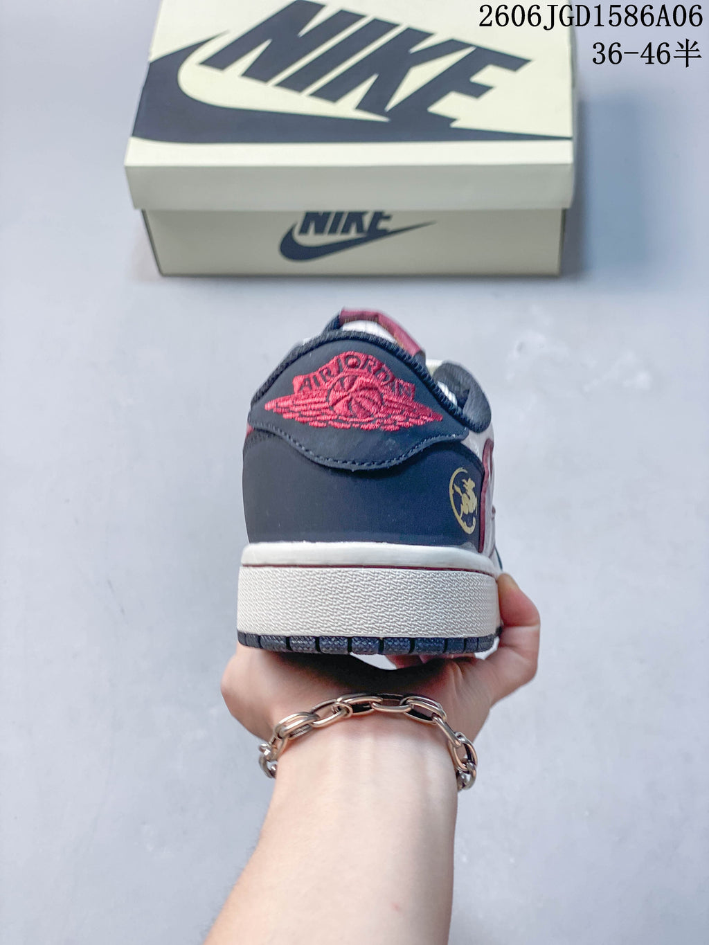 Rear view showing the navy heel, red embroidered detail, and white midsole