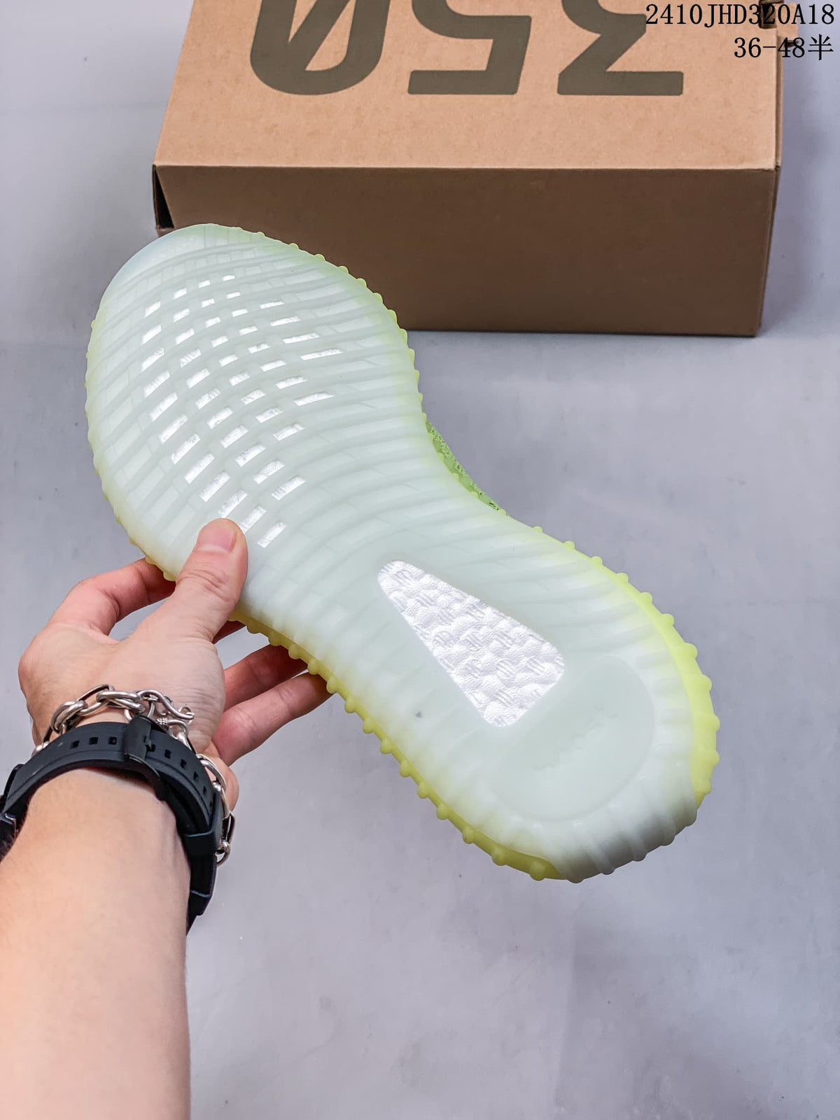 Close-up of the ribbed translucent-looking sole on a green and white sneaker