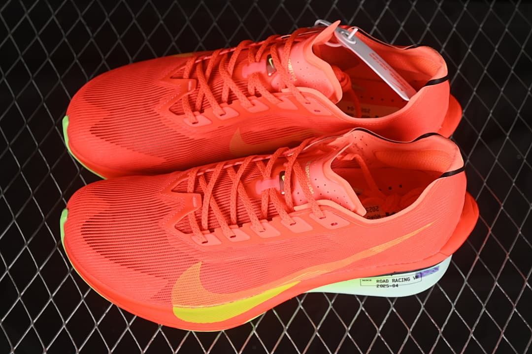 Pair of coral-red running shoes shown from above and the side.