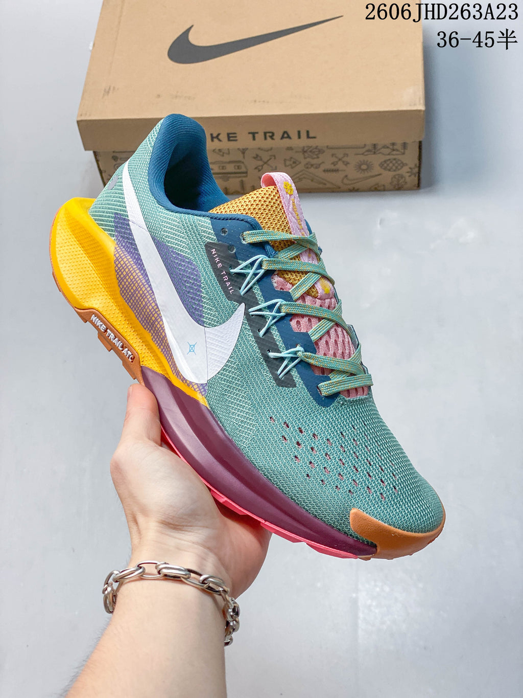 Angled side view of the teal Nike Pegasus Trail 5 with a white Swoosh and colorful details.