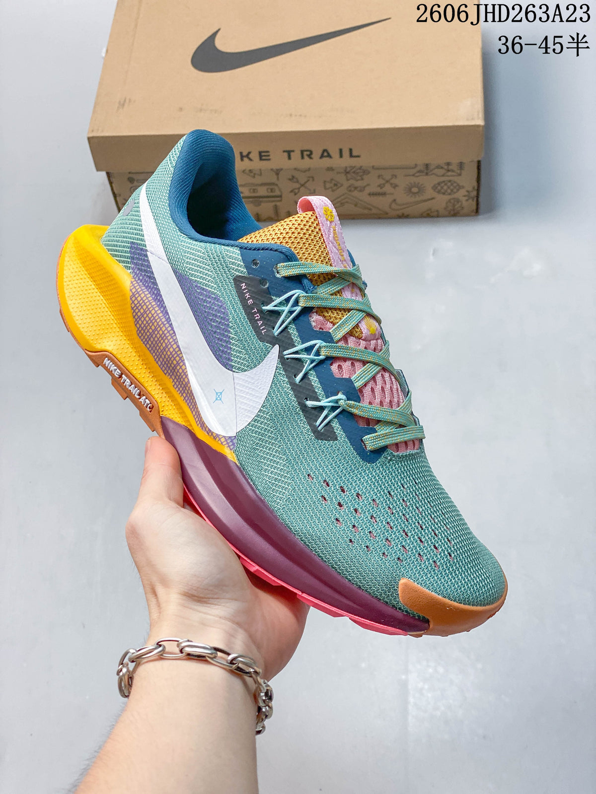 Angled side view of the teal Nike Pegasus Trail 5 with a white Swoosh and colorful details.