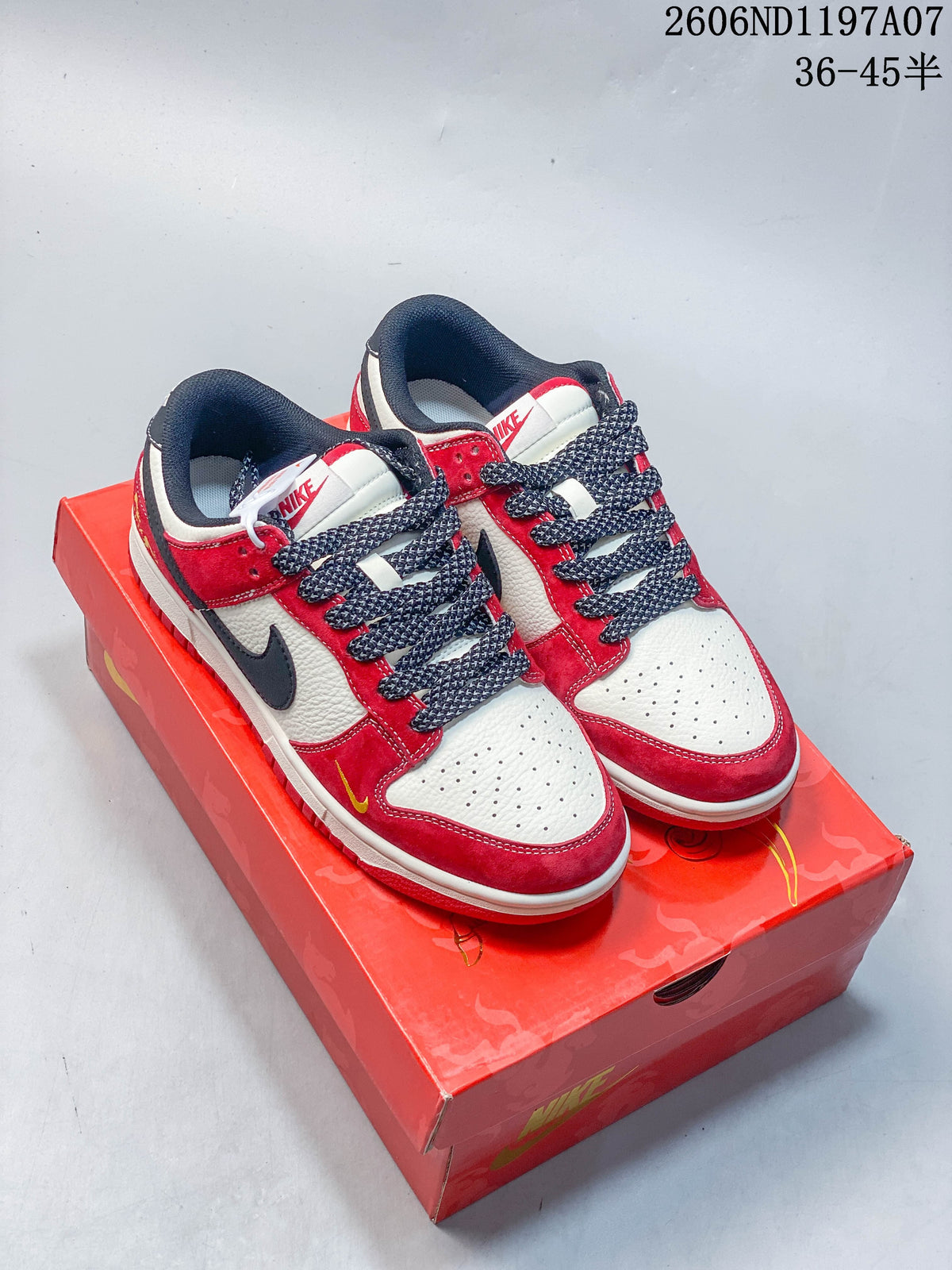 Pair of red, off-white, and navy Nike SB Dunk Low sneakers on a red box