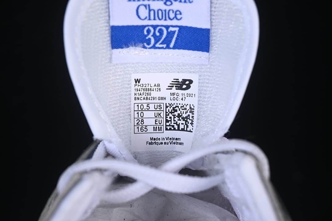 Tongue label on the New Balance 327 sample showing EU 28, UK 10, US 10.5, and 165 mm.