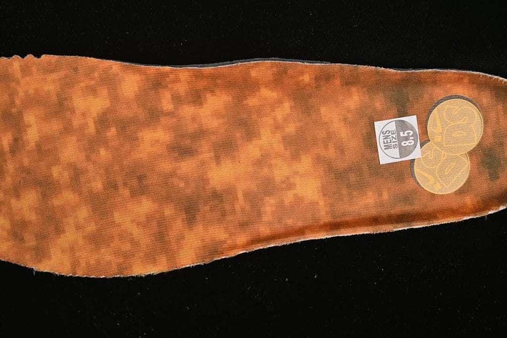 Orange-brown patterned insole with a visible men's size 8.5 label.