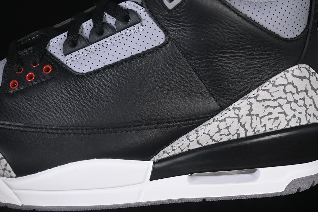 Detail of the black upper, perforated grey panel and elephant-print heel overlay