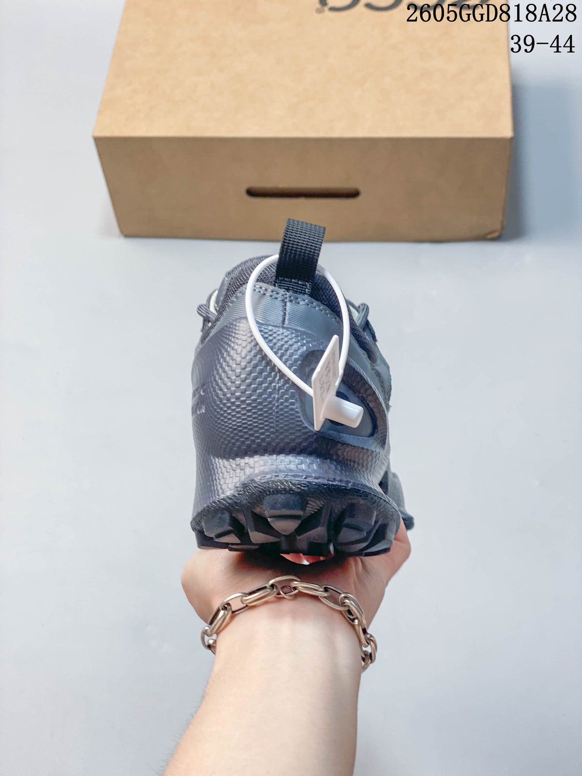 Rear view of the gray sneaker showing the heel and outsole