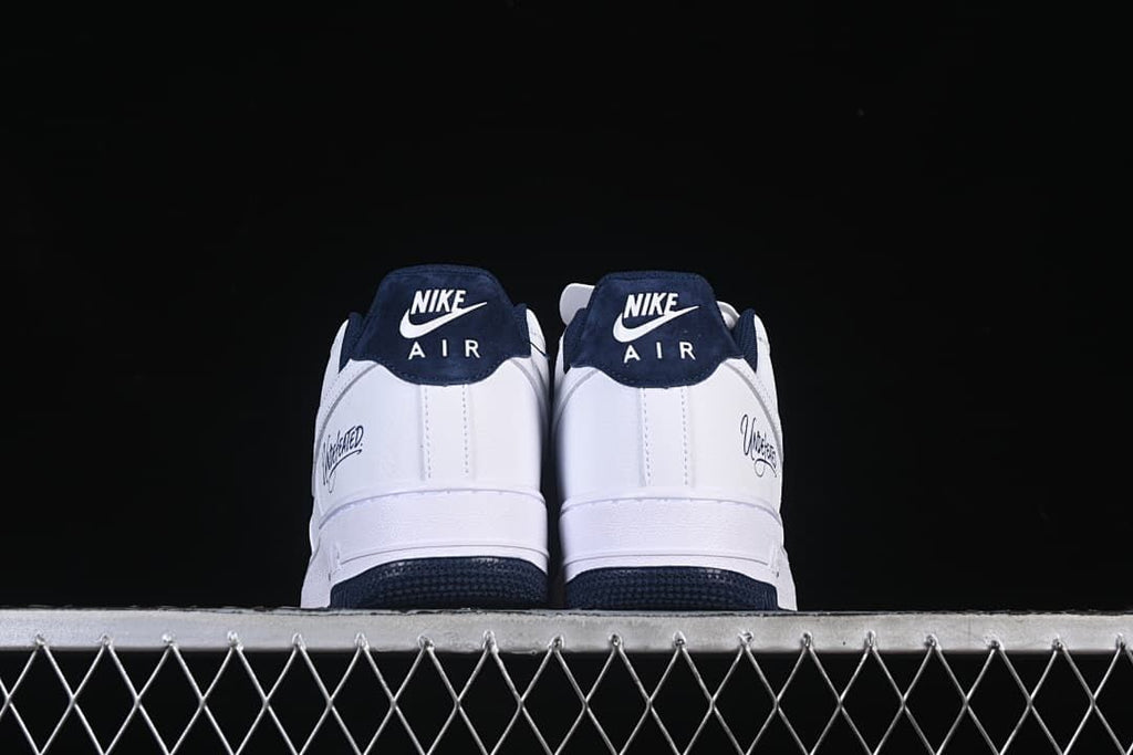 Rear view of the pair showing navy heel tabs and Undefeated side details
