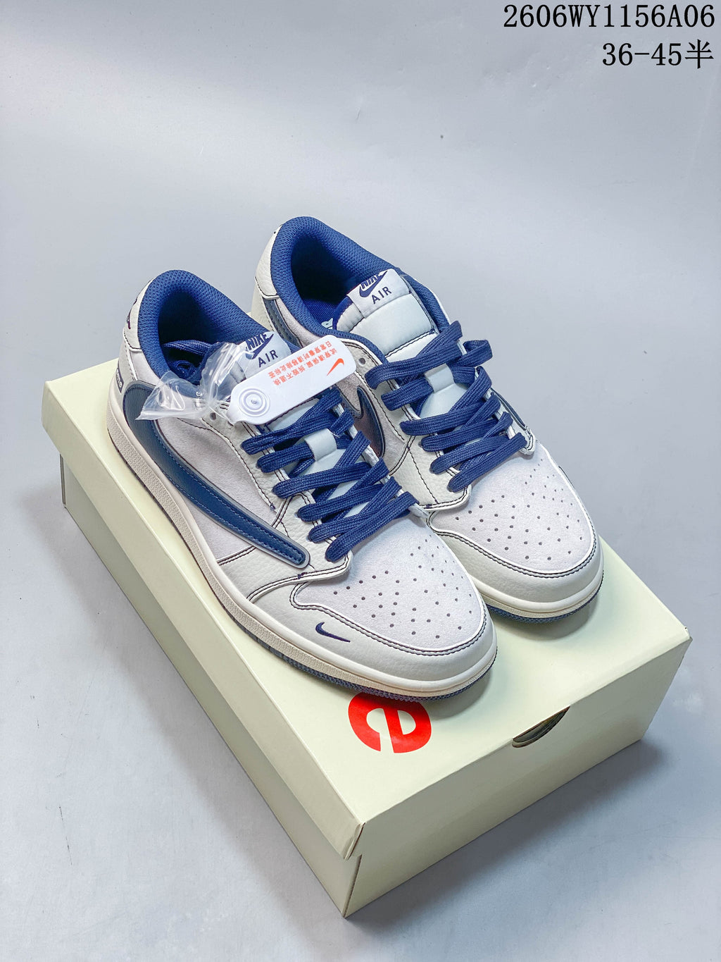 Pair of white and royal blue low-top sneakers with perforated toe panels and blue laces