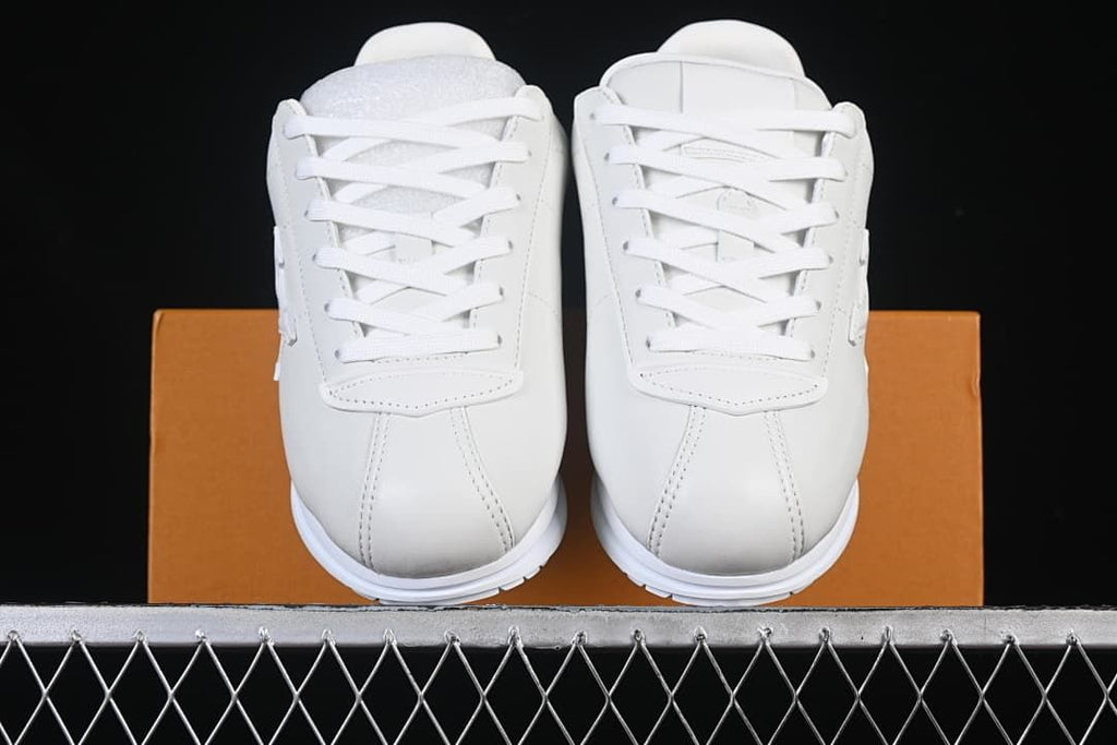 Front view of the pair of white lace-up sneakers