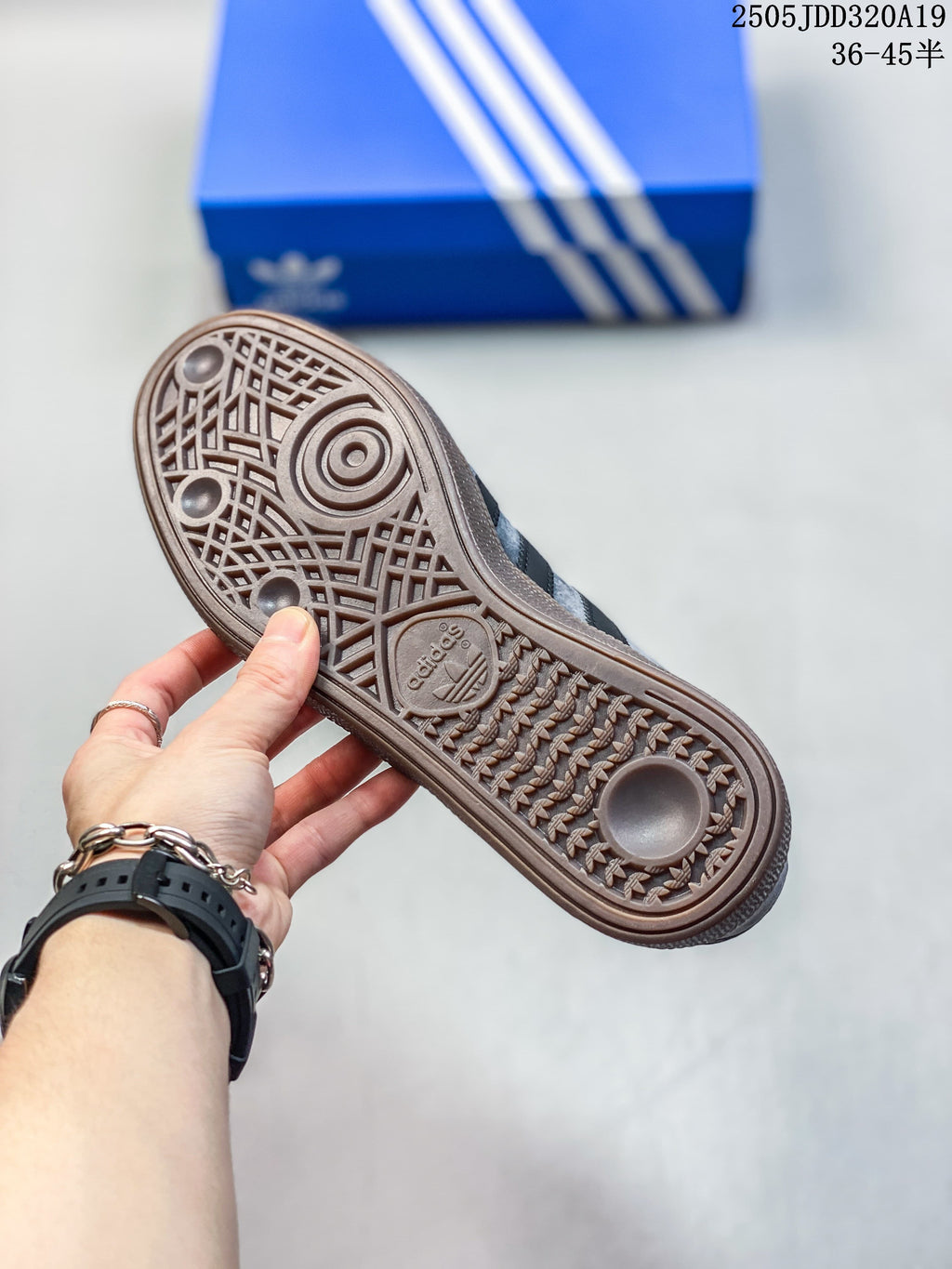 Close-up of the patterned brown outsole on a grey sneaker.