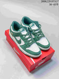 Pair of green and white low-top Nike sneakers displayed on a red box